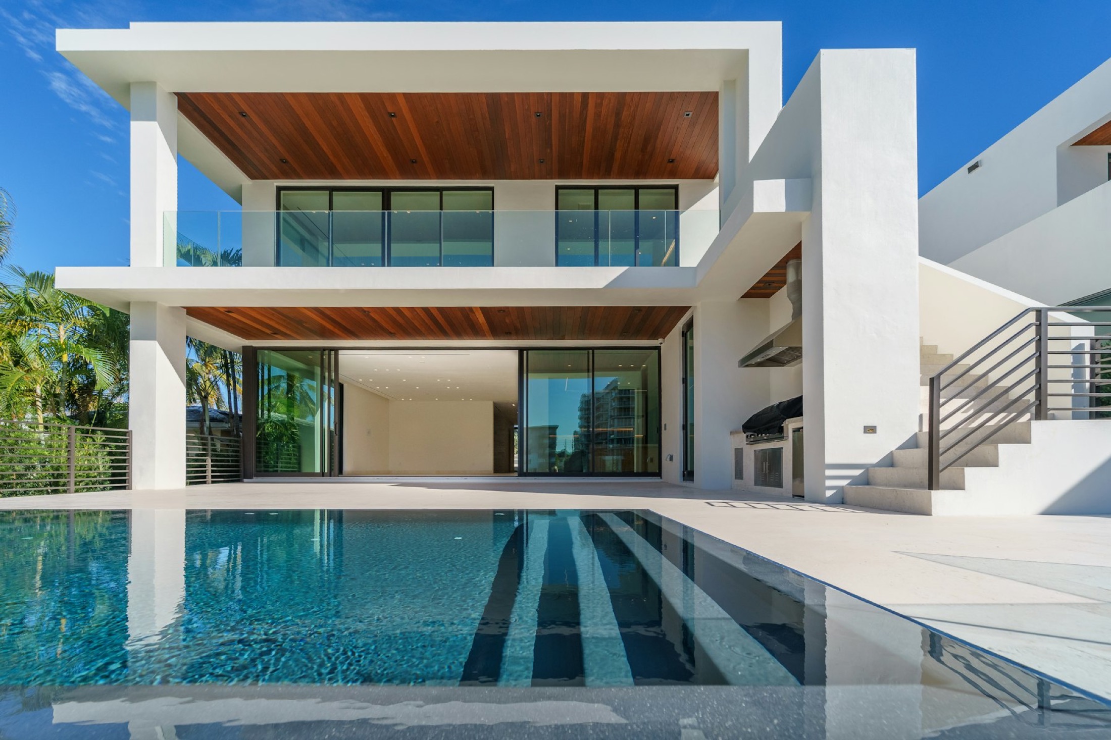 White modern villa with a long reflecting pool