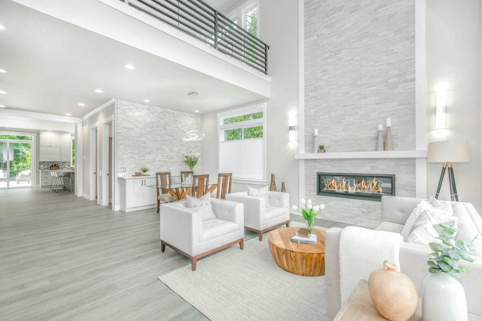 Bright double-height living room with fireplace