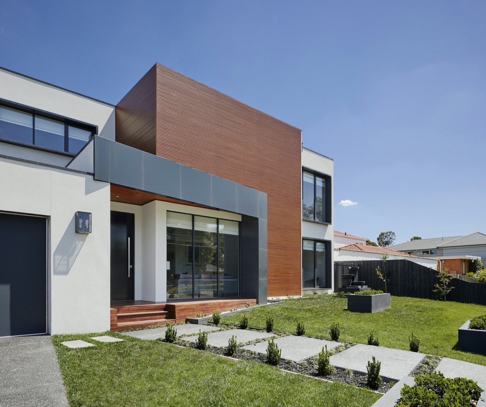 Modern white and cedar-clad family home
